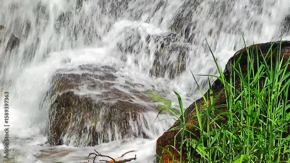 A 20-second still video of the Alzeau River waterfall in Saint Denis, Aude. A waterfall set amidst rocks in the south of France.
