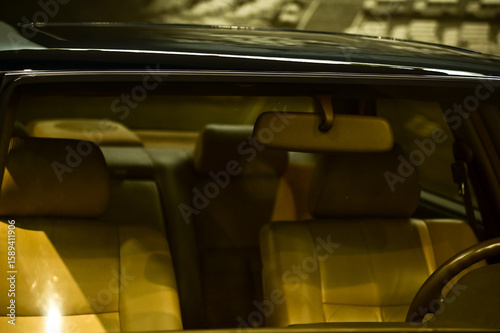 Detail of the interior of a vintage car. Retro car. Close-up of the old steering wheel, console, seats, insides of the  retro car. Interior of a classic vintage car