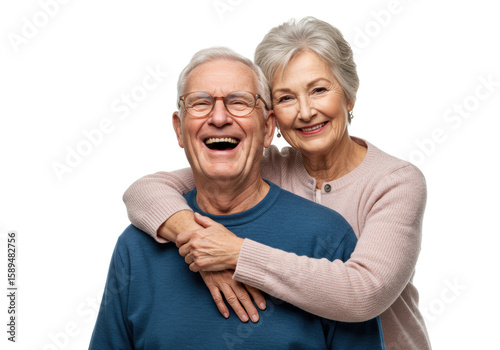 Elderly caucasian man laughing heartily in blue sweater, embraced by elderly woman in pink cardigan, both looking at camera on transparent studio background with copy space, enduring love and family