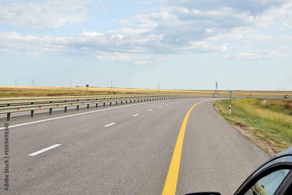 Fototapeta premium Cars drive along a modern expressway