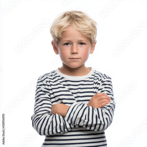 Blonde boy with arms crossed in striped shirt isolated on white background showing confidence and poise