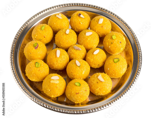 Top-Down View of Traditional Besan Laddus in Round Plate with Pistachio Garnish, Isolated on Transparent Background.