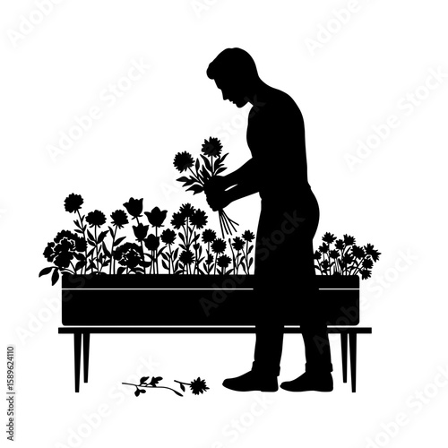 Man gardening and arranging flowers in elevated planter box  