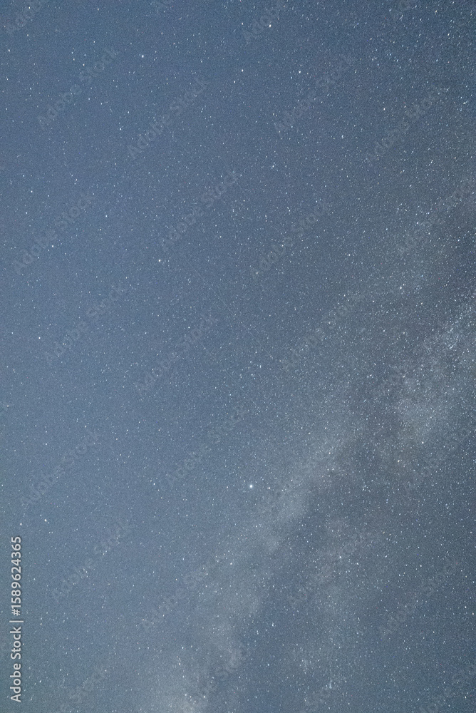 Fototapeta premium Starry night sky over a tranquil landscape during a clear evening showcasing the beauty of the Milky Way and distant celestial bodies