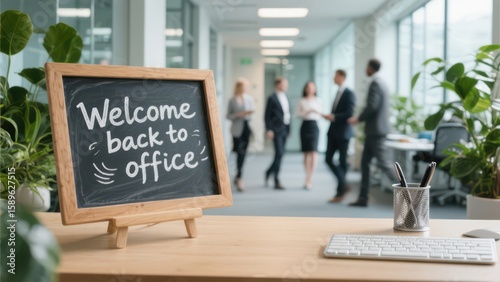 Welcome back to office message on desk with business team returning to workplace after holidays.