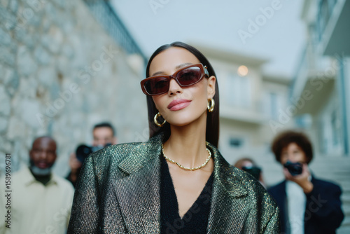 Celebrity walking past paparazzi taking photos