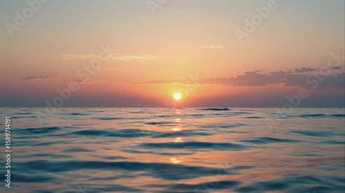 Beautiful ocean horizon during sunset featuring colorful sky and water reflections
