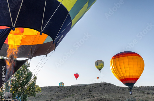 A group of hot air balloons are flying in the sky