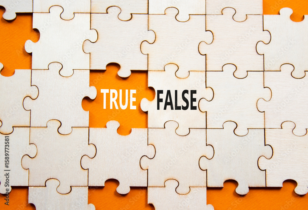 Fototapeta premium True or False symbol. Concept word True or False on wooden puzzle. Beautiful orange background. Business and True or False concept. Copy space