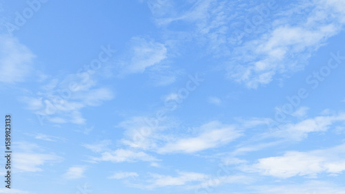 Clear blue sky with soft cloud with daylight natural background. Soft white clouds float in the clear blue sky. Clear blue sky, bright spring, soft sky gradient.