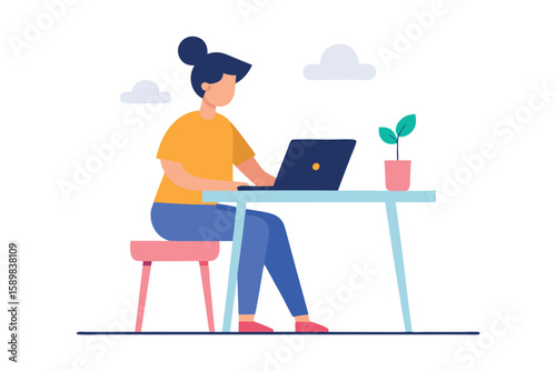 A woman works diligently on her laptop at a desk