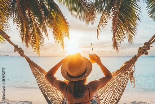 Woman relaxing in hammock with tropical cocktail at sunset beach for vacation getaway