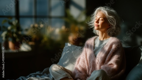 Sunlight casts a warm glow on a woman enjoying a peaceful moment in a cozy room with plants