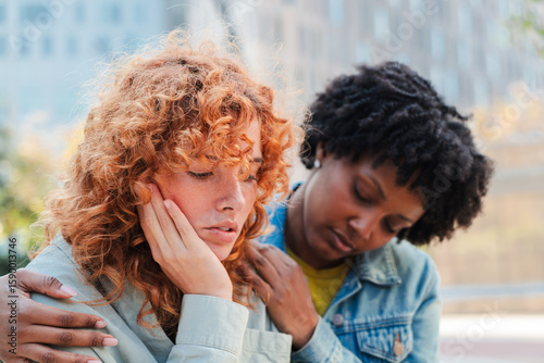 Obraz na płótnie Two women engage in a supportive moment where one friend offers comfort and empathy to another experiencing emotional distress and sadness, showcasing the importance of friendship and support