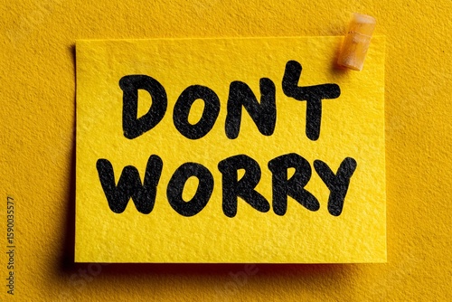 Encouraging message on sticky note against a vibrant yellow background in a positive setting