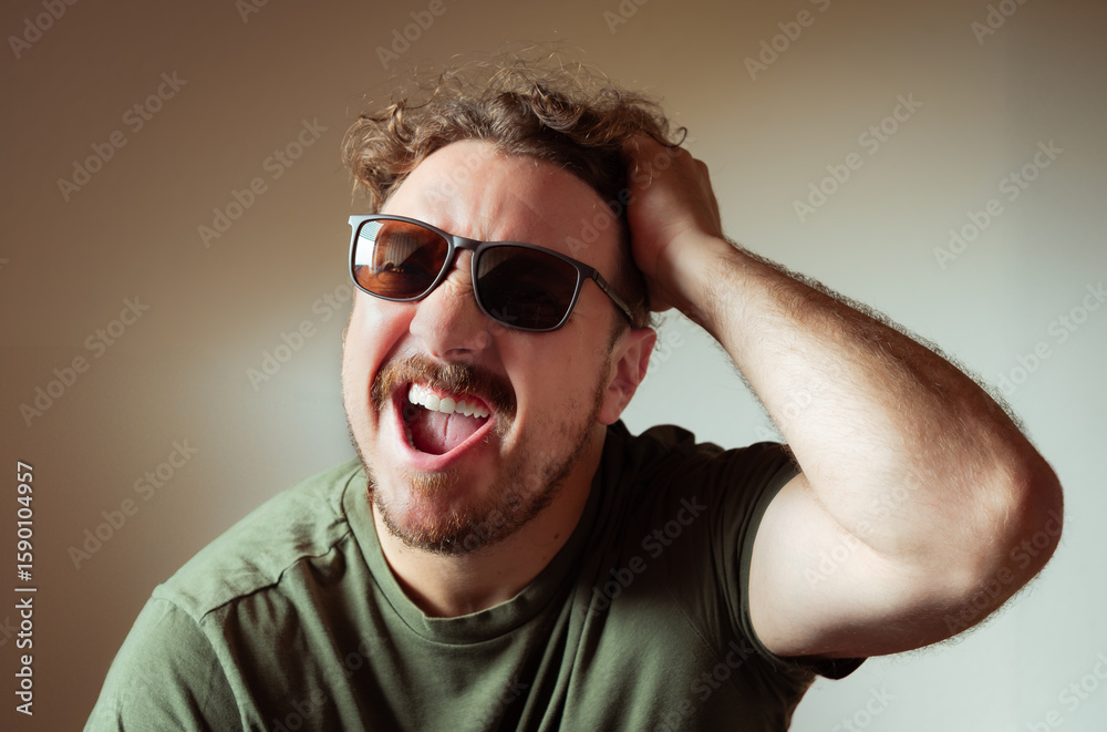 Obraz premium Man with Sunglasses Yelling or Reacting Strongly