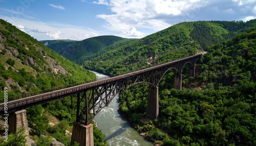 A long metal bridge spans a valley