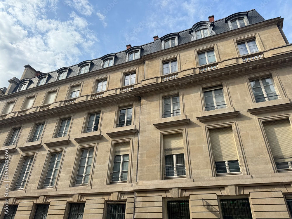 Obraz premium Facade of high building with brick walls and big windows