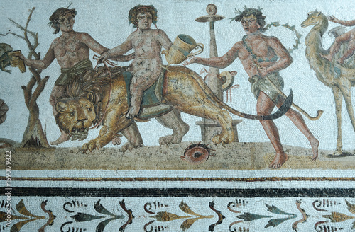 Dionysus riding a lion. Around him, a Bacchanta dancing and playing thetambourine, El Jem mosaic,Tunisia