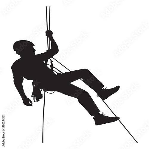 Silhouette of a person rappelling down a rope wearing a helmet and harness engaged in an extreme sport or outdoor adventure activity