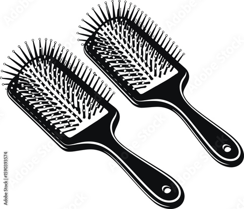 Two black paddle hair brushes with rounded pins isolated on white background