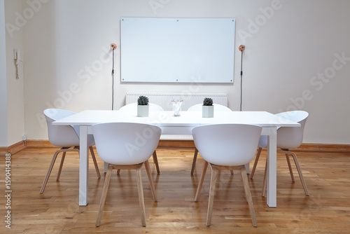 Conference room with white chairs