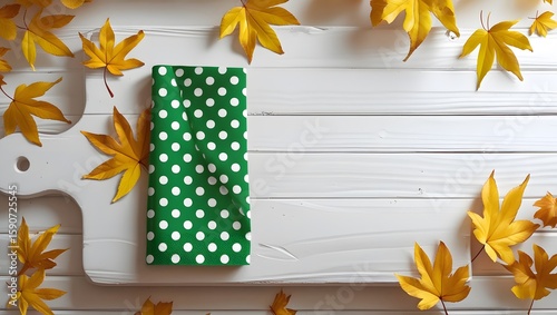 Conceptual Fall Background with Yellow Leaves on White Wooden Surface
