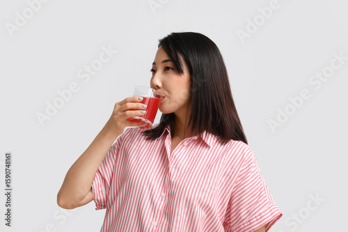 Beautiful Asian woman drink...