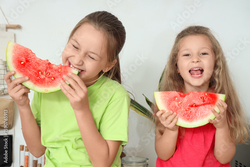 Happy little girls eating f...
