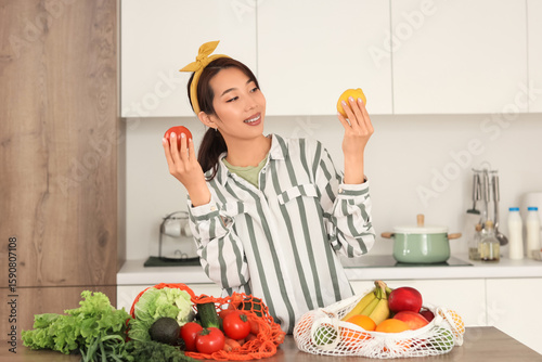 Young Asian woman unpacking...