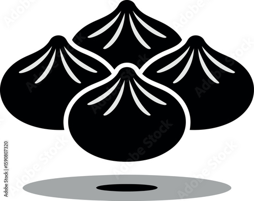 Four black dumplings in a row with shadow silhouette