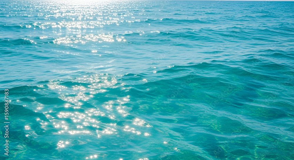 Obraz premium Sparkling turquoise water surface reflecting sunlight.