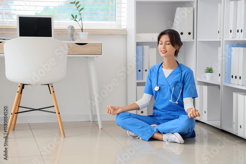 Female doctor meditating on...