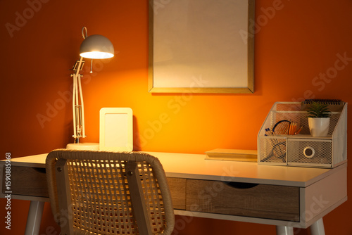 Workplace with glowing lamp...