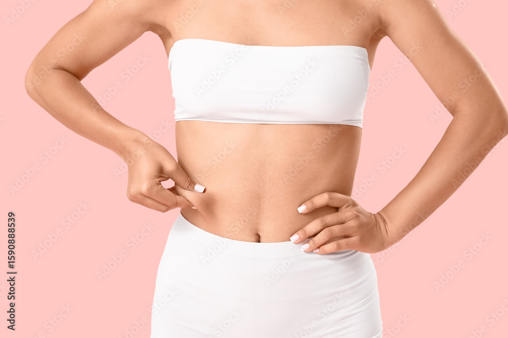 Young woman in underwear with cellulite problem on pink background Young woman in underwear with cellulite problem on pink background