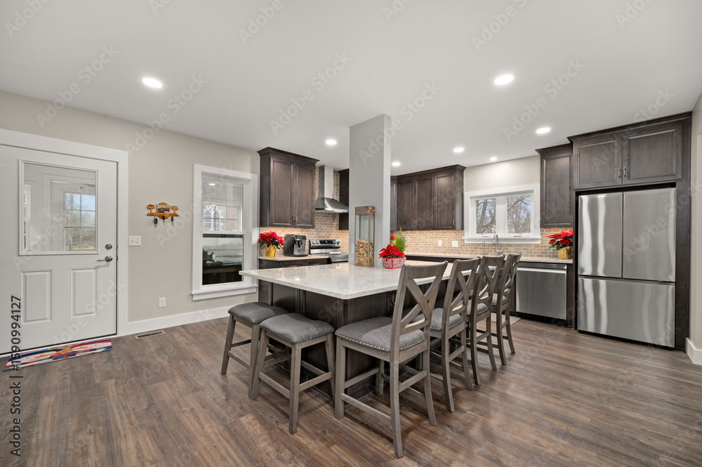 Fototapeta premium Bright modern kitchen with sleek island and stainless steel appliances