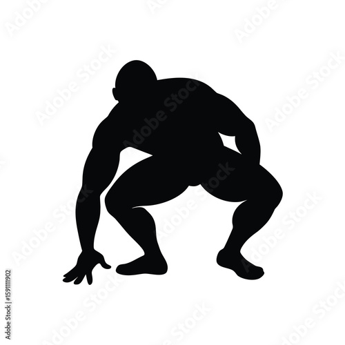 Dynamic black silhouette of a wrestler in a defensive stance ready to attack