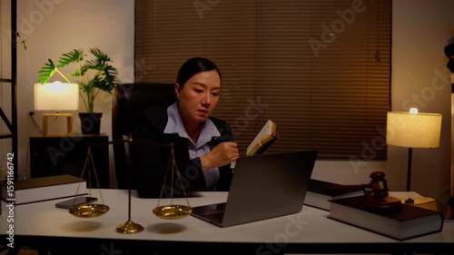 Lawyers sit reading legal books.