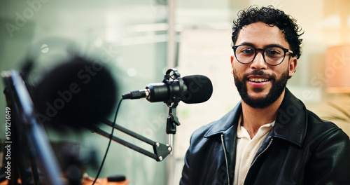 Microphone, podcast and portrait of man in recording studio for live streaming or radio broadcast. Content creation, glasses and smile with influencer person on air for journalism, media or talk show