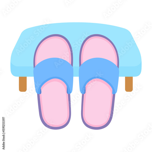 A pair of pink and blue cartoon slippers resting neatly on a small light blue stool.