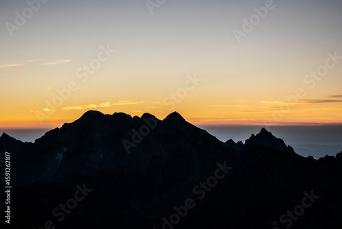 Mountain peaks at sunrise. Sunlight falling, painting with light, Rysy in the Polish Tatra Mountains