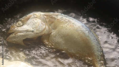 Close-up of Fried Mackerel in Hot Oil on a Pan.
