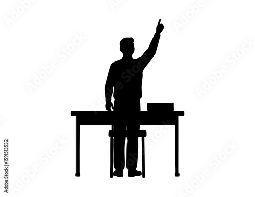 Man standing raising one finger behind desk, pointing upward, symbolizing idea, question, leadership, authority, or making an important statement in office.