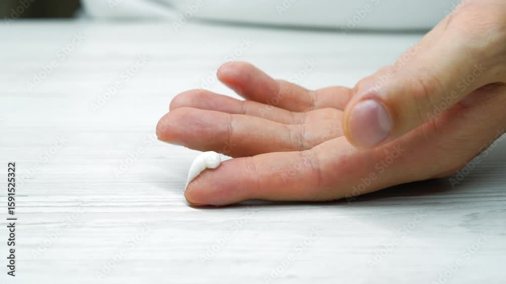 hand cream close-up on a man's hands.
A person takes care of the health of his hands and treats cracks and dry skin.
Health and body care hand cream close-up on a man's hands.
A person takes care of the health of his hands and treats cracks and dry skin.
Health and body care