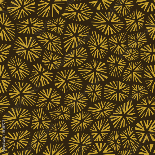 Yellow starburst pattern radiates across brown background with bold symmetrical geometric design