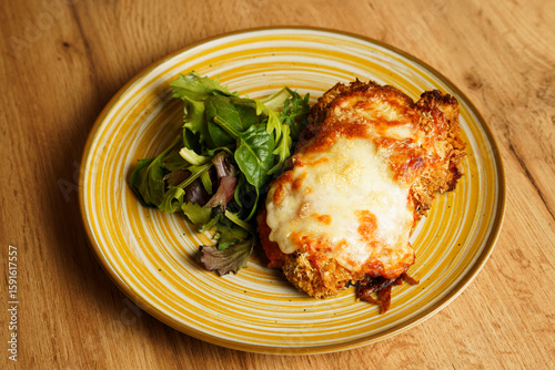 Crispy chicken parmigiana with salad