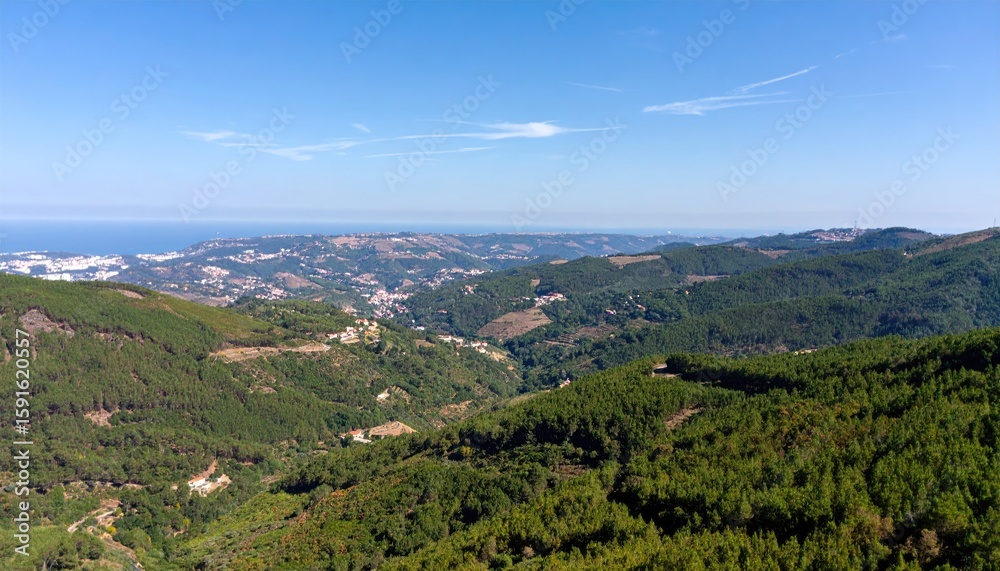 Obraz premium Panoramic mountain vista with town and ocean