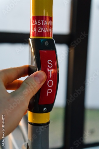Hand Pressing Stop Button in Bus