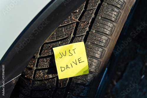 Just Drive – Handwritten Note on Car Tire