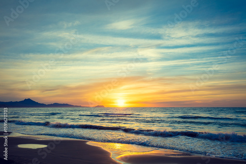 Seascape in early morning during a beautiful purple sunrise. San Juan beach, Alicante, Spain, Europe